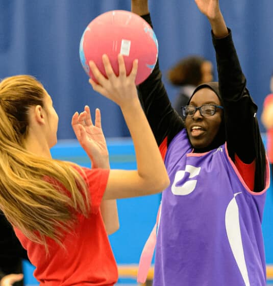 sc-cs-sportengland-hero Two girls playing sports